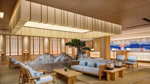 A modern interior with a seating area, a large rock feature, and a mural on the wall. - Libre Resorts Huangshan (Huangshan)