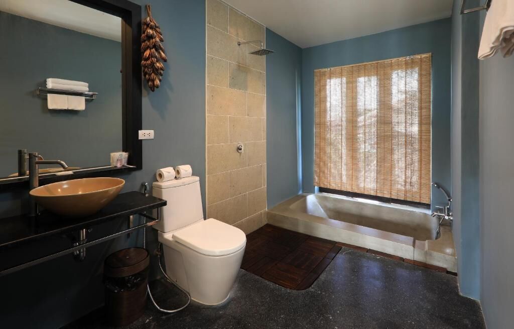A bathroom with a large sink, toilet, and bathtub.