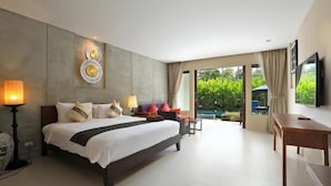 A modern hotel room with a large bed, a desk, and a view of a swimming pool. - Tea Tree Boutique Resort (Rawai)