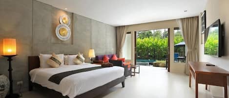 A modern hotel room with a large bed, a desk, and a view of a swimming pool.