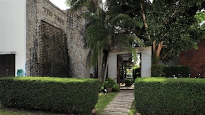 A stone building with a sign reading "TEA TREE". - Tea Tree Boutique Resort (Rawai)