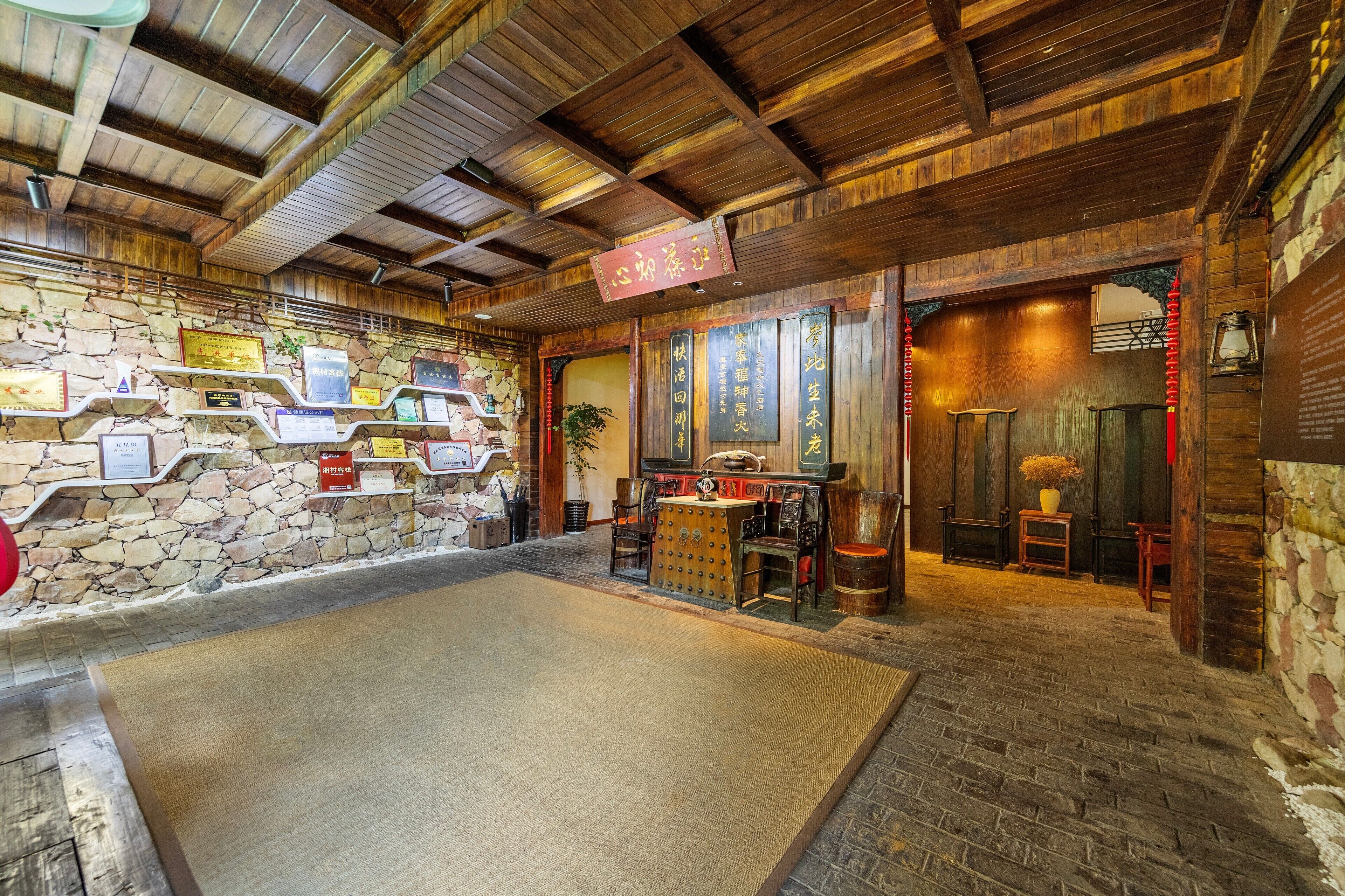 A traditional interior with stone walls, wooden beams, and a tatami mat area.