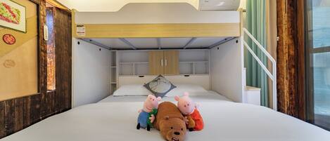A bedroom with a bunk bed, a bed with plush toys, a wooden headboard, a window with curtains, and a wall-mounted air conditioner.