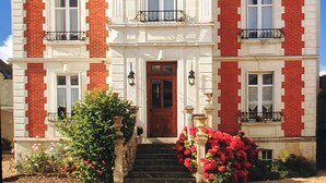 A large, two-story building with a steeply pitched roof, red brick walls, and white trim. - Manoir Du Parc - Adults Only (Amboise)