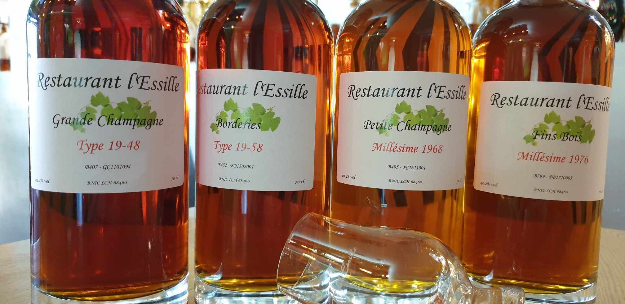 Four bottles of wine from Restaurant l'Essille, including Grande Champagne Type 19-48, Bordervies Type 19-58, Petite Champagne Millésime 1968, and Millésime 1976.