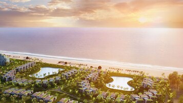 A resort with multiple swimming pools, beachfront villas, and a large building likely for hotel services.