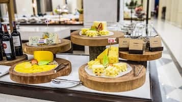 A cheese and wine tasting display with various cheeses and wine bottles.
