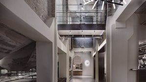 A modern interior with a central staircase, glass railings, and a minimalist design. - Boutique Hotel Ottilia (Copenhagen)