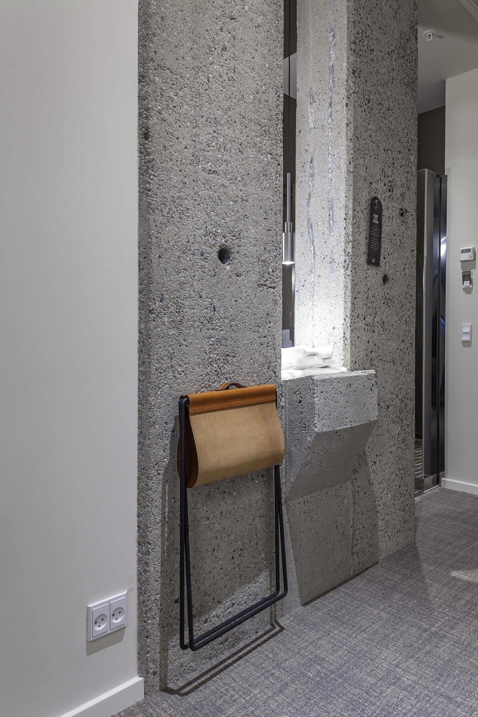 A modern bathroom with a granite countertop, a towel rack, and a mirror.