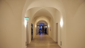 A hallway with arched ceilings and a sign indicating an exit. - Klosterhotel Kreuz (Metzerlen)