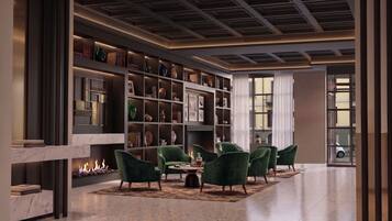 Un interior moderno con chimenea, sillones verdes y una estantería.