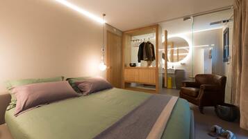Una camera da letto moderna con un letto, un armadio in legno, uno specchio, una sedia e un tavolino.