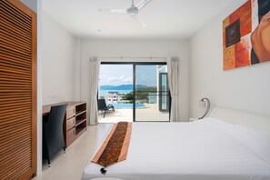 A hotel room with a bed, a desk, a chair, a view of the outdoors, and a ceiling fan. - 2 Bed Seaview Villa A2 SDV202-By Samui Dream Villas (Koh Samui)