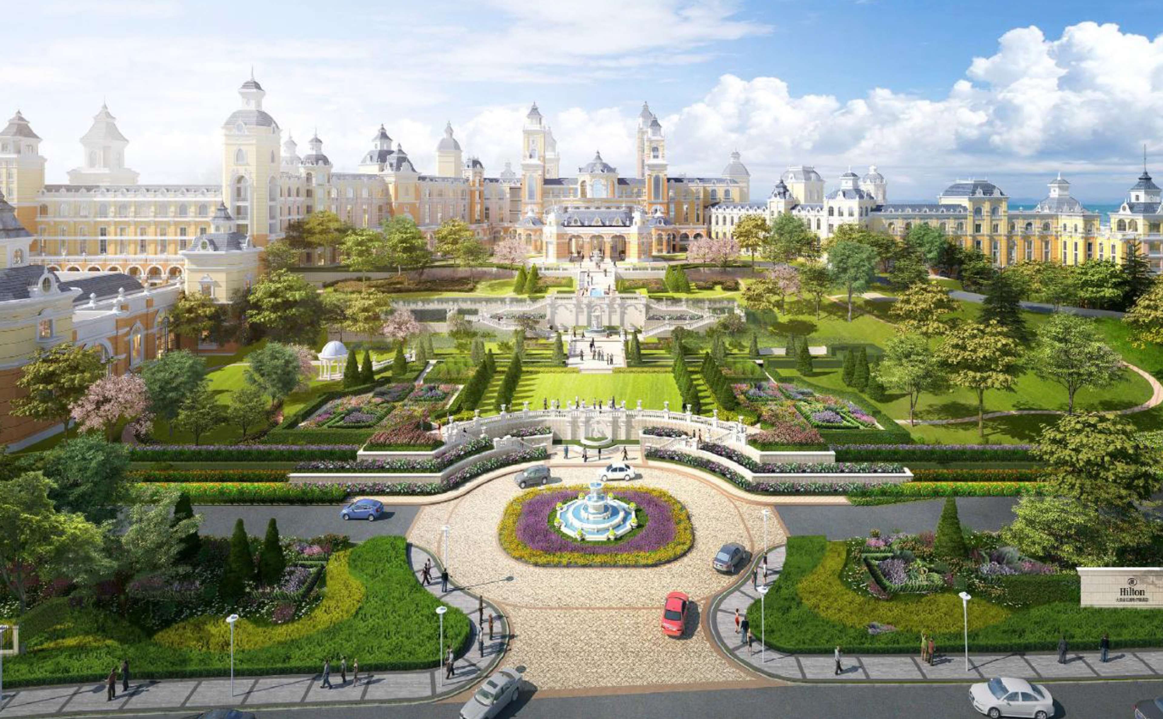Un hotel elegante con una fuente central, jardines cuidados y arquitectura clásica.