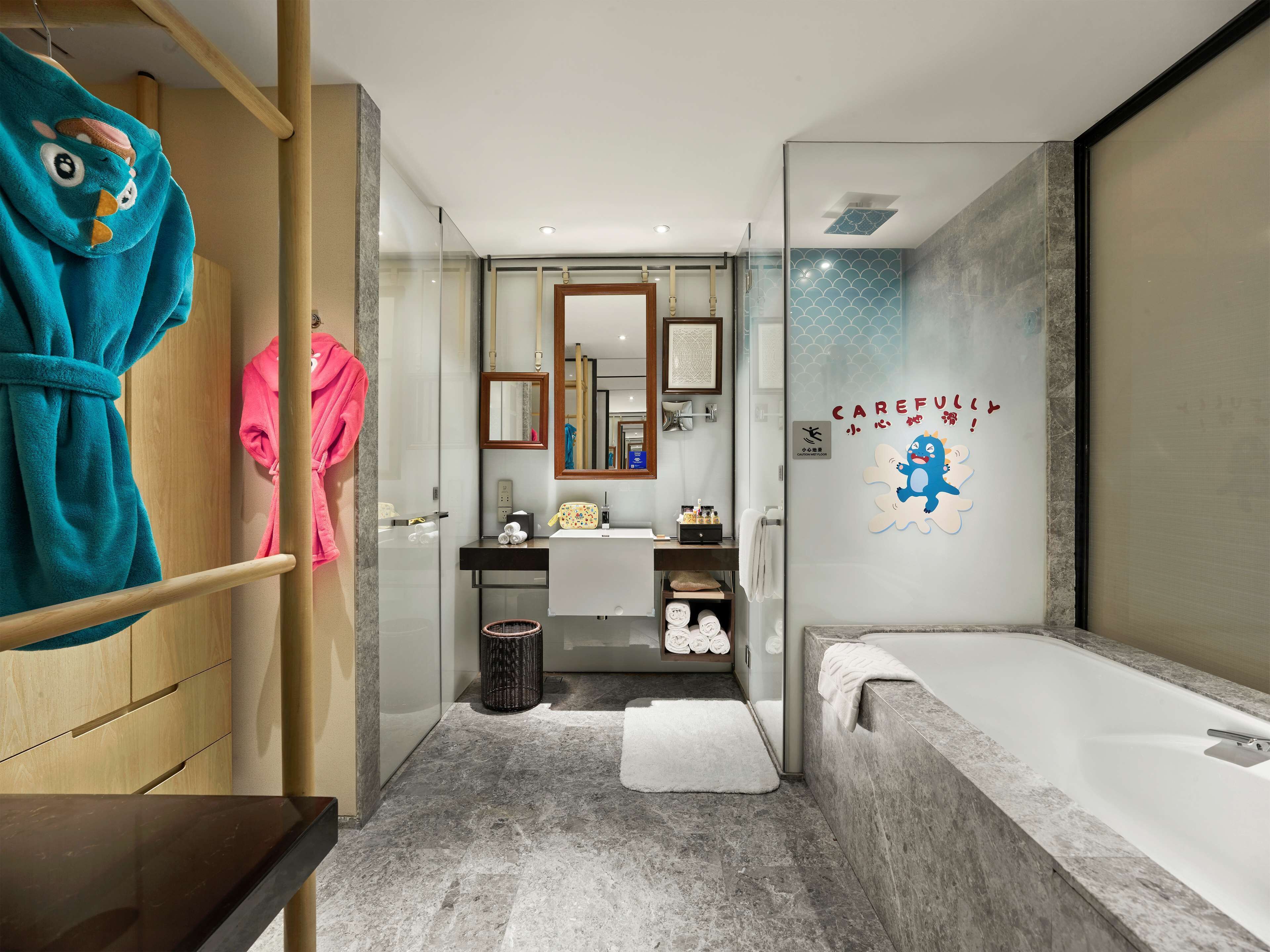 A modern bathroom with a bathtub, a glass shower enclosure, and a vanity with a mirror.