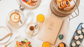 A breakfast setting with various dishes, a coffee cup, and a menu.