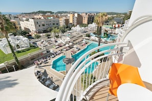 A resort with multiple swimming pools, a covered area with umbrellas, and a view of the surrounding cityscape. - Hotel Best Lloret Splash (Lloret de Mar)