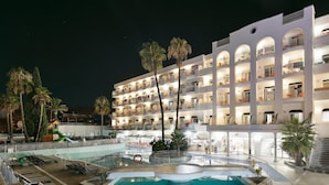 A hotel with multiple balconies, a swimming pool, and palm trees. - Hotel Best Lloret Splash (Lloret de Mar)