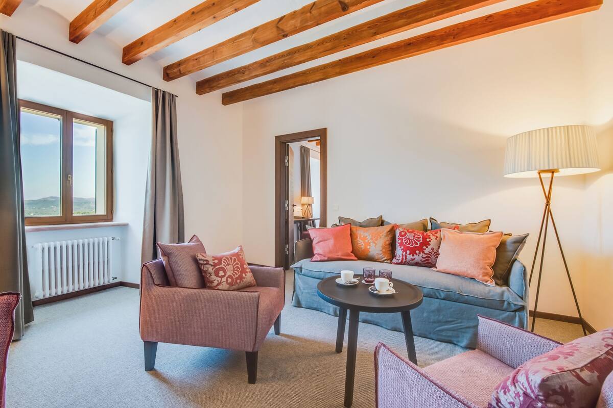 A cozy living room with a sofa, armchairs, and a coffee table.