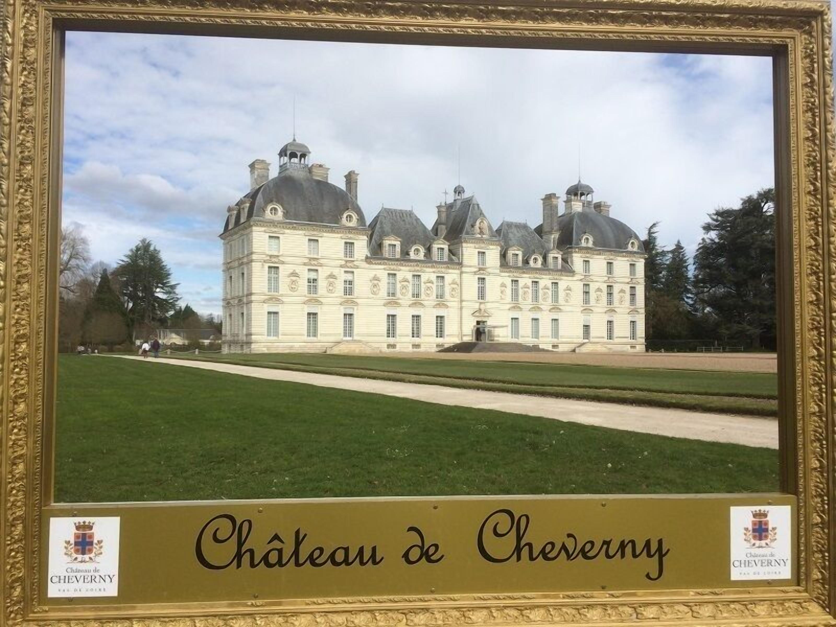 The Château de Cheverny, a large, historic building with multiple towers and a symmetrical facade.