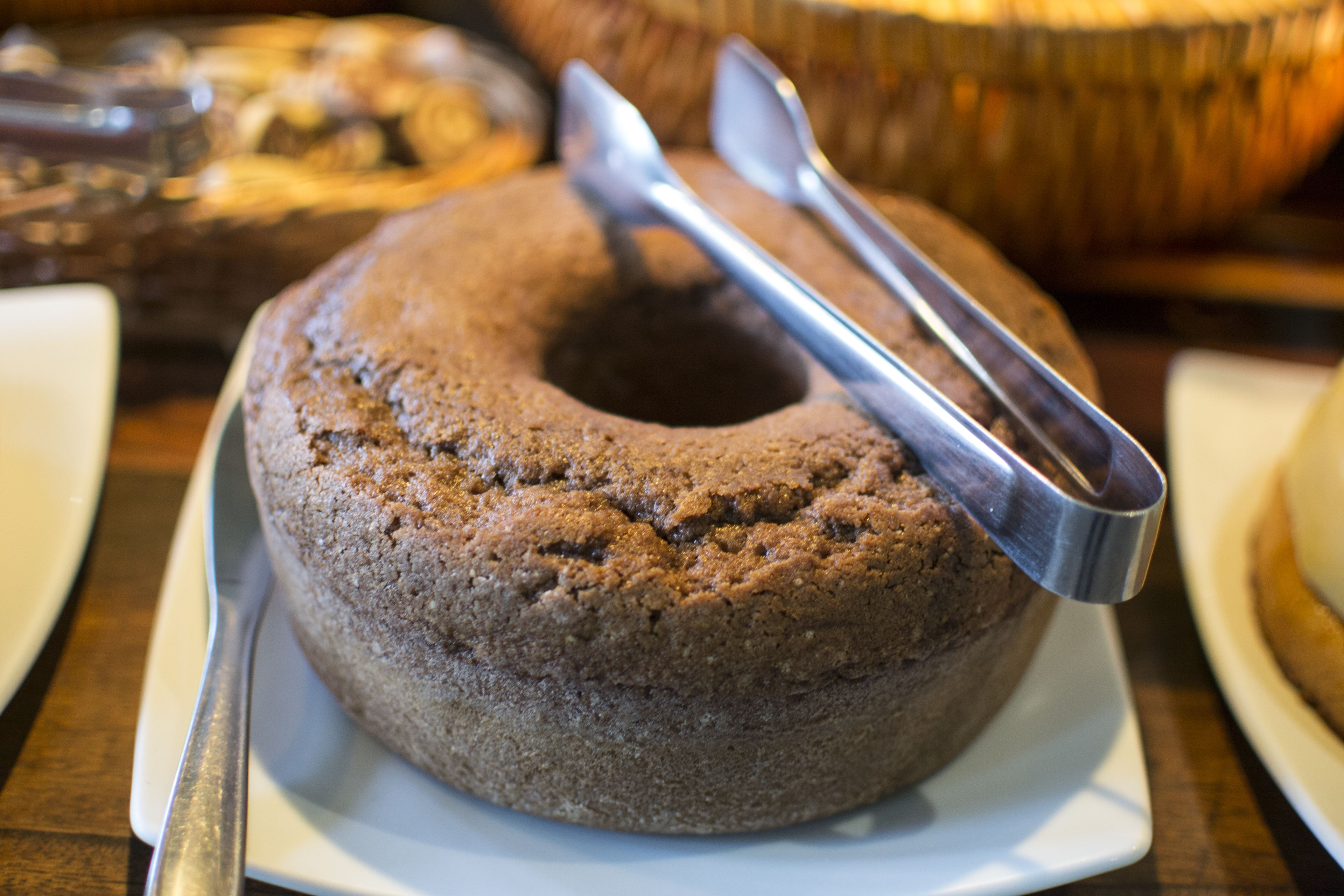 A cake on a white plate with a cake server.