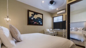 A hotel room with a large bed, a desk, a chair, and a TV. - Casa Arte Hotel Boutique by HMC - Adults Only (Cartagena)