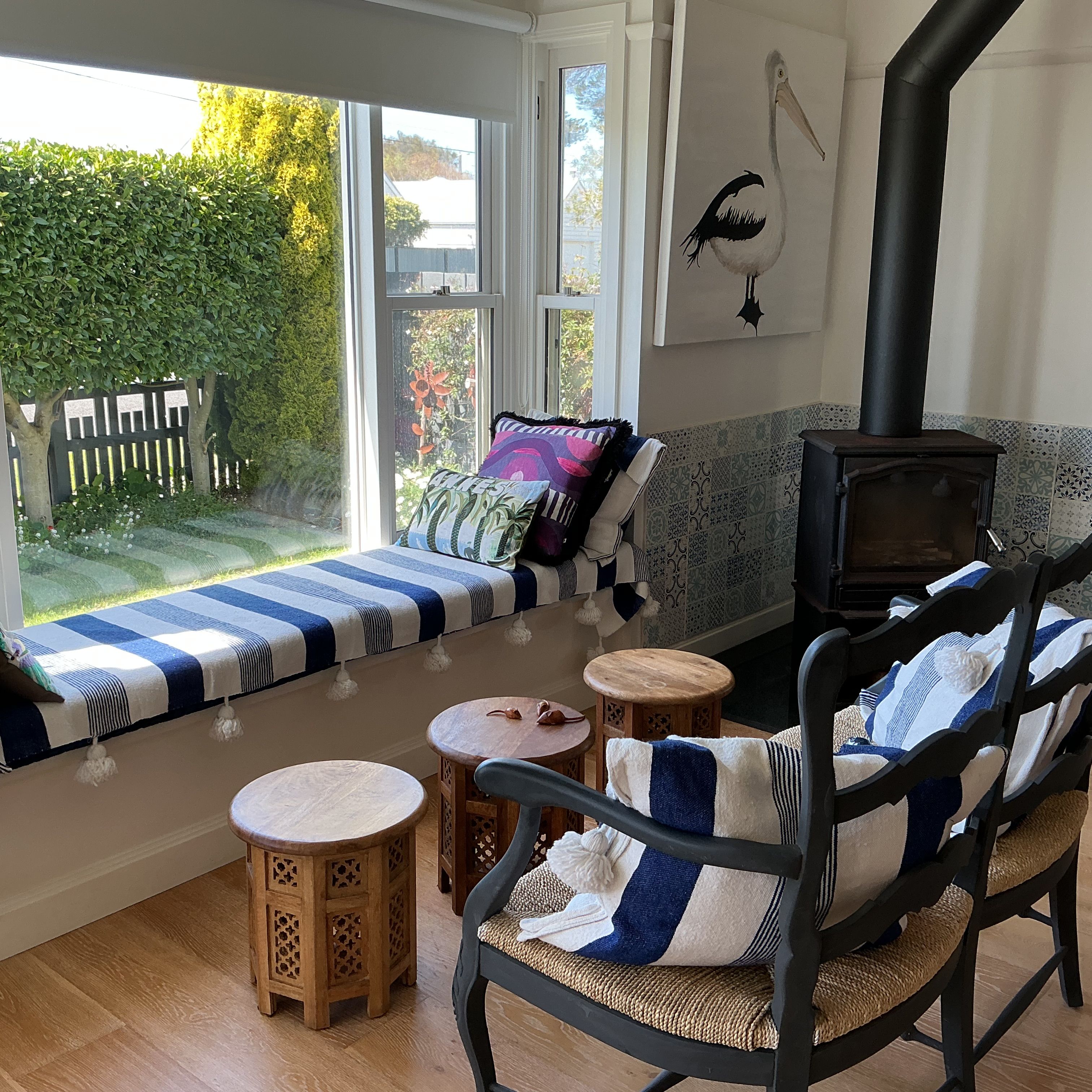 A cozy seating area with a sofa and chairs, a small table, and a fireplace.