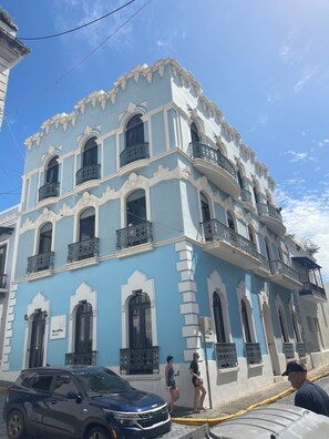 A multi-story building with ornate balconies and a blue facade. - Luquillo, 13th Floor with Ocean Front! (Luquillo)