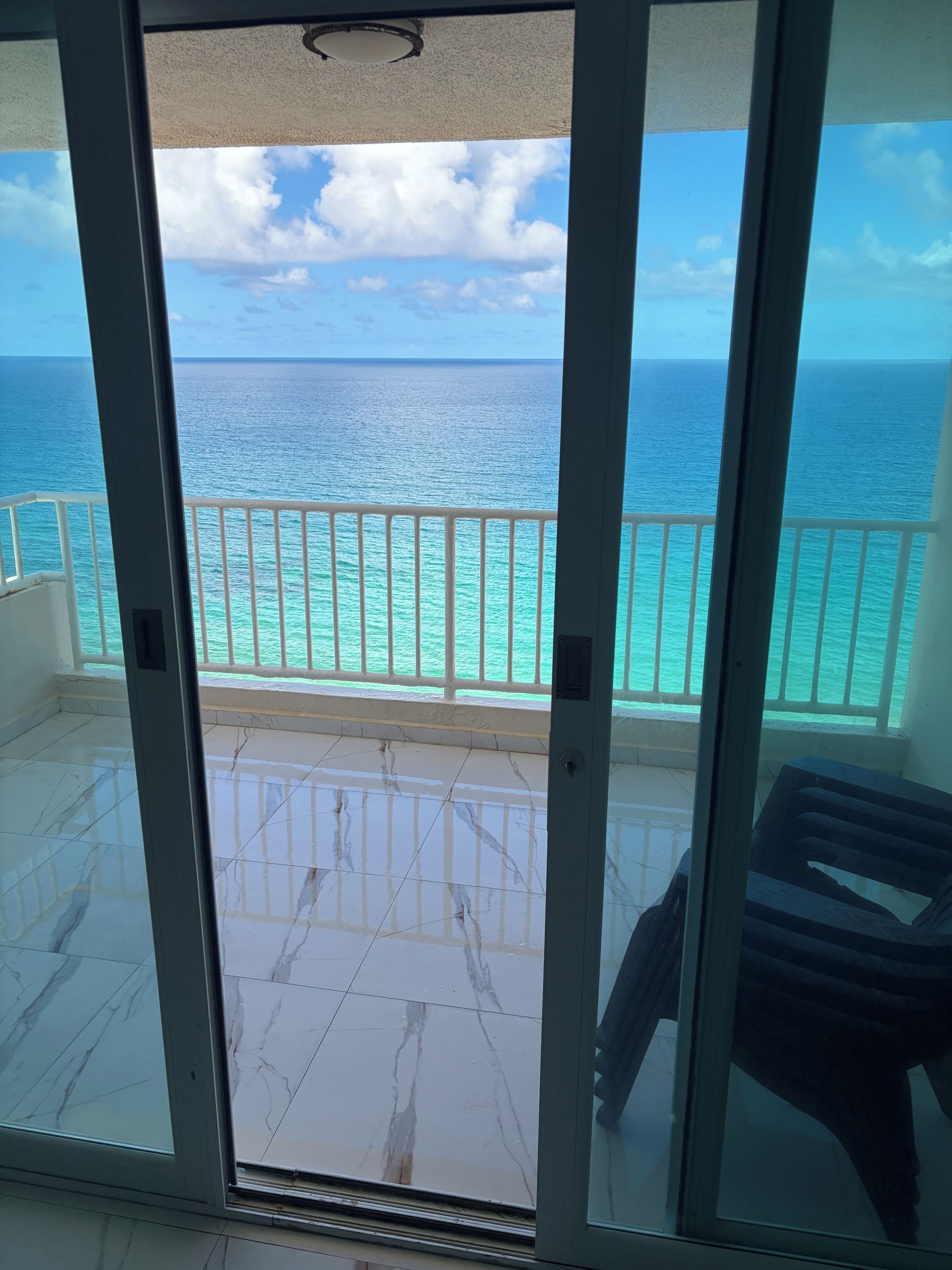 A balcony with a view of the ocean.