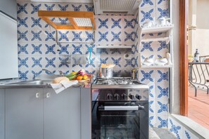 A kitchen with a stove, oven, and a sink.