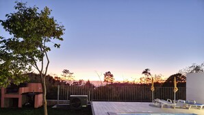A backyard with a swimming pool, a wooden deck, a grill, and a fence. - Home for Nature Tourism, Madeira Island LAURISHOUSE, Nature and Sea (Prazeres)