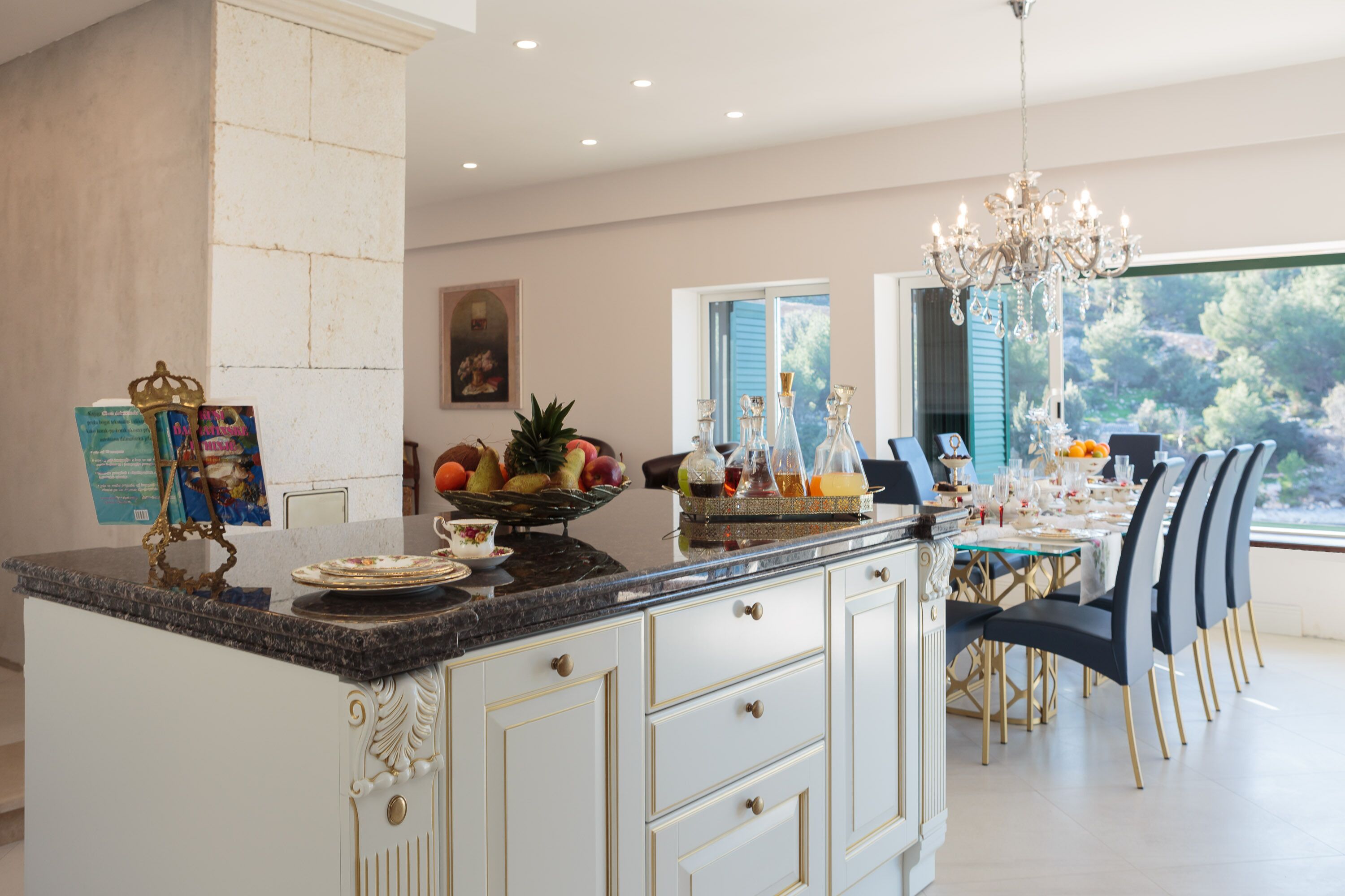 A spacious kitchen with a large island, modern appliances, and a dining area with a view.