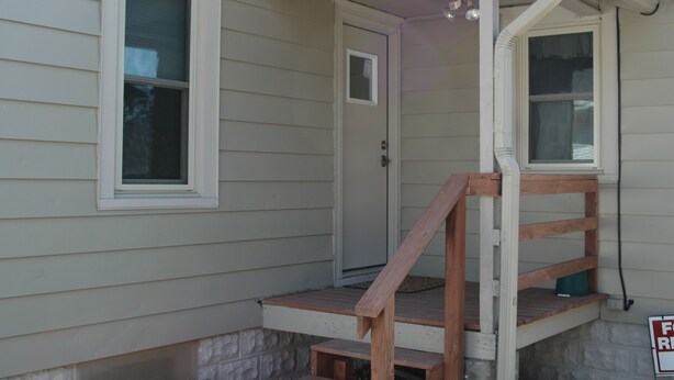 A house with a front porch, a door, and a window. - Bethany Bungalow, 2 Bdrm, 1 Bath bungalow near all Husker events (Lincoln)