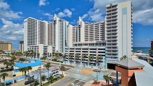 A high-rise hotel with multiple floors, a parking garage, and a view of the ocean. - Ocean Front Delight - Ocean Walk (Daytona Beach)