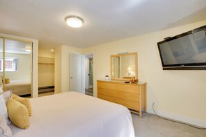 A bedroom with a bed, a dresser, a mirror, and a TV. - Lincoln City Beach Condo: Clubhouse & Pool Access! (Lincoln City)
