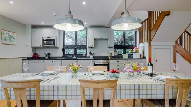 A modern kitchen with white cabinets, a central island, and pendant lighting. - ★Walnut Tree Cottage★ Huge garden+village setting+near Canterbury+dog friendly (Canterbury)