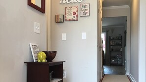 A hallway with a wooden floor, a bench, a mirror, and a wall with motivational decor. - Have a "Hakuna Matata" apline vacation in Style & Luxury!! (Helen)