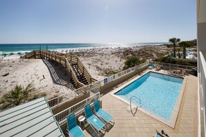 A pool area with a view of the beach, a wooden deck, and lounge chairs. - GD 215: White Sand Wonders - Life’s a Beach so Live it in Style! (Fort Walton Beach)