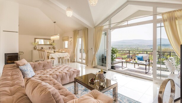A spacious living room with a large sofa, a dining area, and a balcony with a view. - Stunning home in Glavina Donja (Glavina Donja)