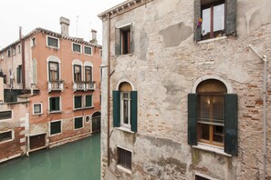 A canal view with buildings featuring arched windows and balconies.