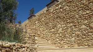 A stone staircase leading up a hill, with a clear blue sky above. - Azure Cottage: Beautiful, modern 3 bedroom apartment with communal swimming pool (Marsalforn)