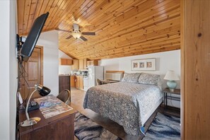 A bedroom with a bed, desk, chair, and a ceiling fan. - 8 bedrooms/ 3 kitchens, 3.1 bathrooms-Seasonal Pool located off site (Port Clinton)