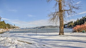 A snowy landscape with a clear view of a river and distant hills. - Cozy Worley Cabin w/ Lake Access + Gas Grill! (Worley)