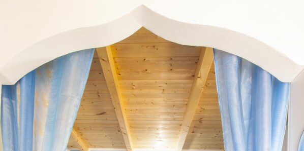 An arched wooden ceiling with visible beams and a white trim.