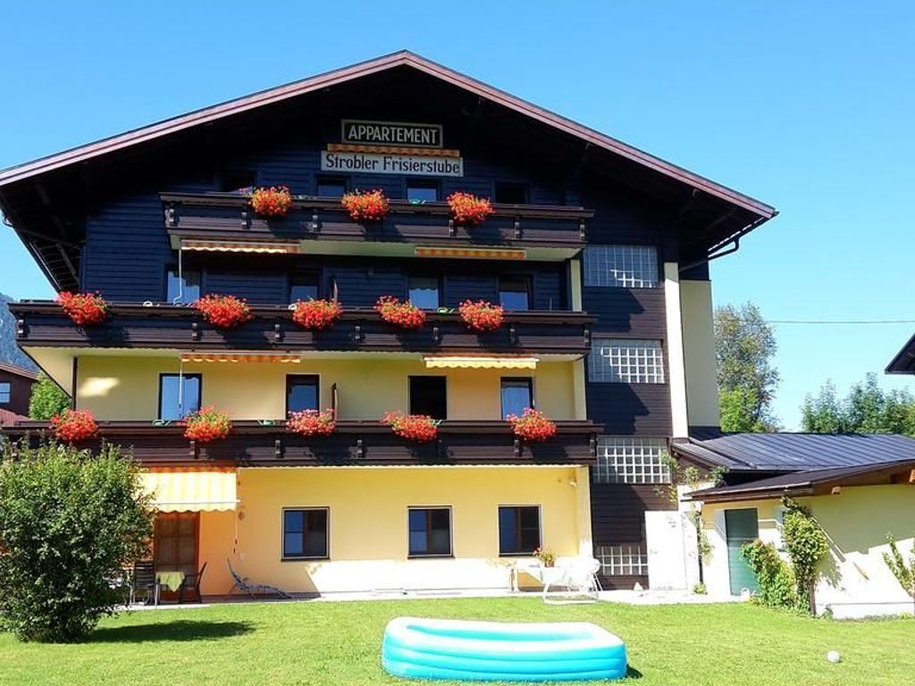 A multi-story building with a sign reading "APPARTMENT" and "Ströbler Frisierstube".