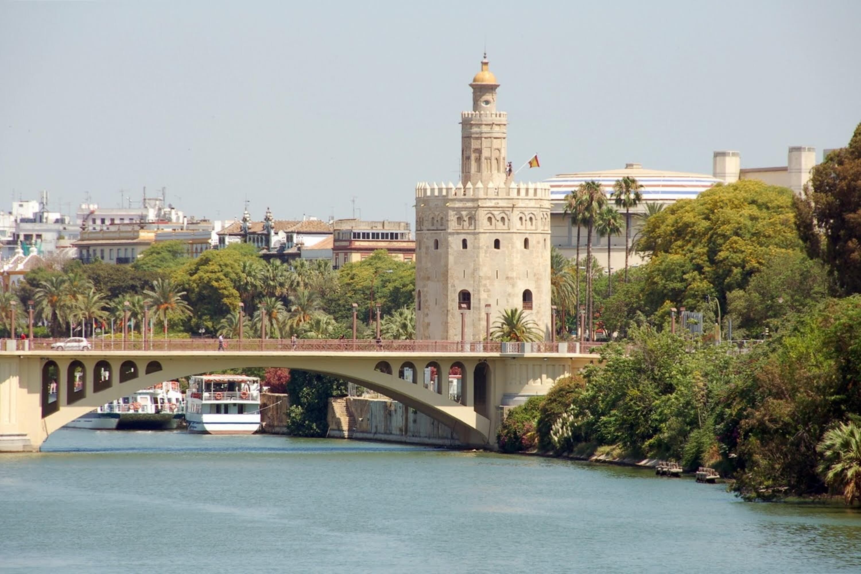 A bridge with a tower and a river.