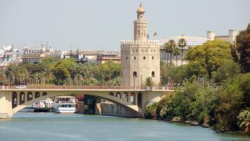 A bridge with a tower and a river.