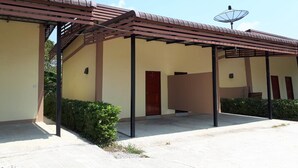 A building with a covered patio area, a satellite dish, and a door. - Dome Resort (Sena)