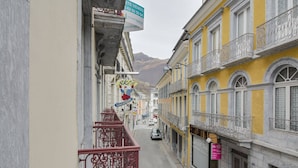 A narrow street with yellow buildings, a visible sign for 'Ski's Location', and a 'Café' sign. - Central Apartment with 1 Bedroom, Ski Locker, Near Lift (Cauterets)