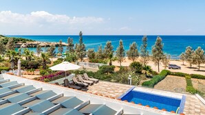 A rooftop pool with a view of the sea, lounge chairs, and a car parked nearby. - Villa Aqua Marina by Ezoria Villas (Protaras)